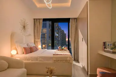 a bedroom with a bed and a large window at Winter Wonderland Studio Azizi Riviera 9 Pool View in Dubai