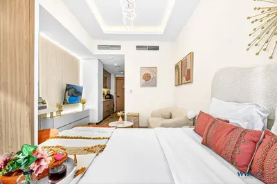 a bedroom with a bed and a living room at Winter Wonderland Studio Azizi Riviera 9 Pool View in Dubai