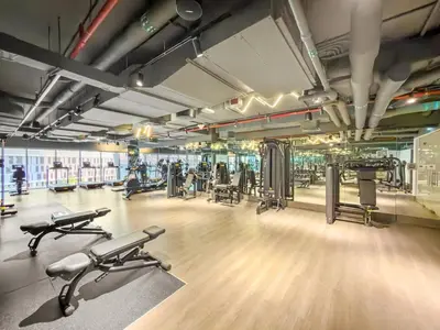 a gym with several treadmills and exercise machines at FIRST CLASS 1BR Burj Views , Prime Location in Dubai