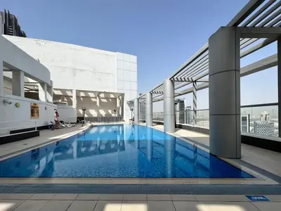 a large swimming pool on the roof of a building at FIRST CLASS 2BR Burj View , Walk to Dubai Mall in Dubai