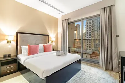 a bedroom with a large bed and a large window at FIRST CLASS Studio Iconic Burj Khalifa View in Dubai
