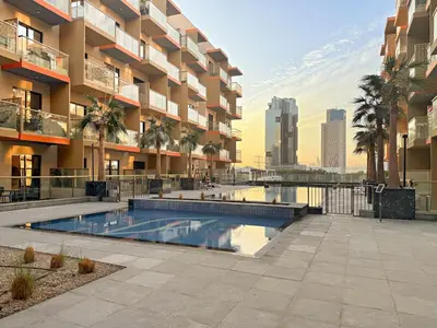 a swimming pool in front of a apartment building at FIRST CLASS 1BR Tranquil Pool View Retreat in Dubai