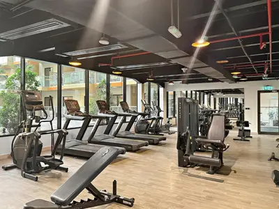 a gym with a row of treadms and machines at FIRST CLASS 1BR Tranquil Pool View Retreat in Dubai
