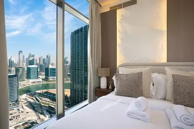 a hotel room with a view of a city at Lux 1BR with Stunning Canal Views in Dubai