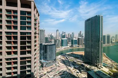 an aerial view of a city with tall buildings at Lux 1BR with Stunning Canal Views in Dubai
