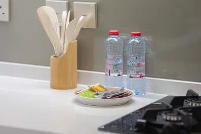 a counter with two bottles of water and a bowl of food at Lux 1BR with Stunning Canal Views in Dubai