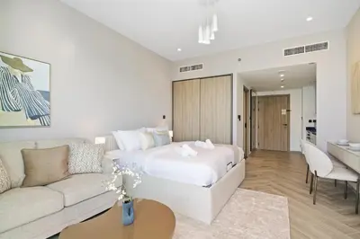 a hotel room with a bed and a couch at Upscale Studio with Peninsula Lifestyle in Dubai