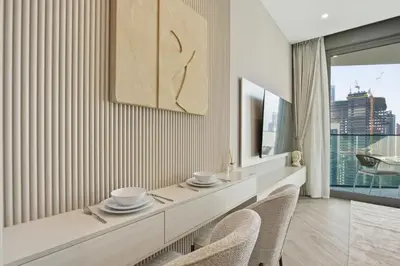 a dining room with a table and two chairs at Upscale Studio with Peninsula Lifestyle in Dubai