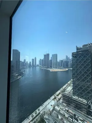 a view of a city from a window of a building at Exquisite Studio - Damac Prive with balcony & canal view in Dubai