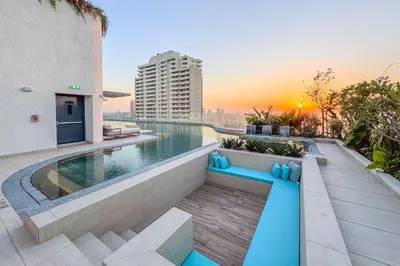 a balcony with a swimming pool on top of a building at Chic 2Bedroom with Exceptional Facilities in JVC in Dubai