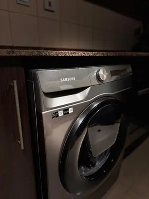 a samsung washer and dryer under a counter at Modern 1BR Marina 3mins walk to JBR Beach & Tram in Dubai