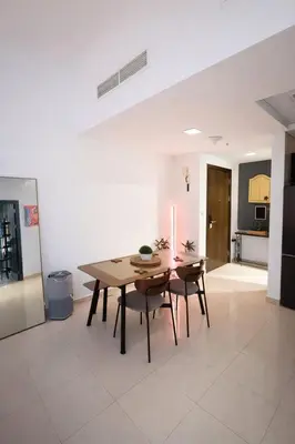 a dining room with a table and two chairs at Modern 1BR Marina 3mins walk to JBR Beach & Tram in Dubai