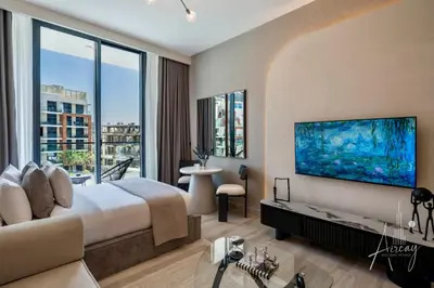 a bedroom with a large bed and a large window at Sunlit Luxe Studio Serene Skies Infinity Pool in Dubai