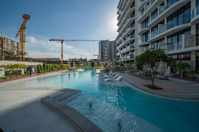 a large swimming pool in the middle of a building at Sunlit Luxe Studio Serene Skies Infinity Pool in Dubai