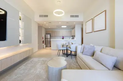 a living room with a couch and a table at Luxury 1 Bedroom Sway Residences Dubai Hills in Dubai