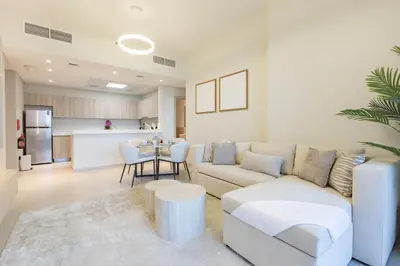 a living room with a couch and a table at Luxury 1 Bedroom Sway Residences Dubai Hills in Dubai