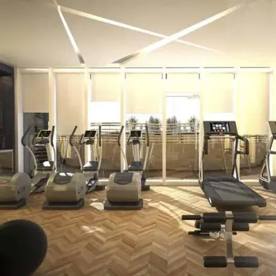 a gym with several cardio machines in a room at Luxury Studio Cozy & comfy 12 Min Walk-Dubai Mall in Dubai