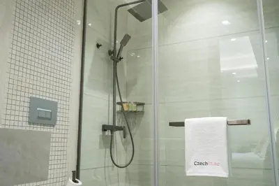 a shower with a glass door and a towel at Luxury 1BR in Nobles Tower - Business Bay Skyline in Dubai