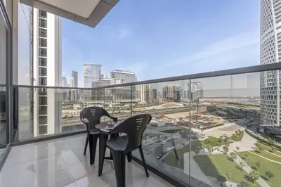 two chairs on a balcony with a view of the city at Luxury 1BR in Nobles Tower - Business Bay Skyline in Dubai