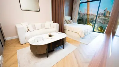a living room with a couch and a coffee table at Luxurious Cozy Studio with Balcony Pool & Gym in Dubai
