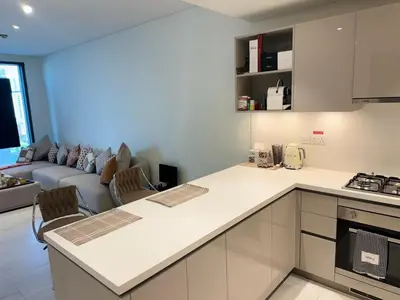 a kitchen and living room with a couch at Creek Comfort and Coziness in Dubai