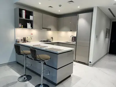 a kitchen with a counter and two bar stools at Creek Comfort and Coziness in Dubai