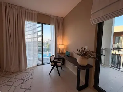 a room with a desk with a computer and a window at Prime Pool Location Spacious Family Villa in Dubai
