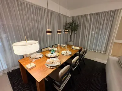 a dining room table with chairs and a tableablish at Prime Pool Location Spacious Family Villa in Dubai