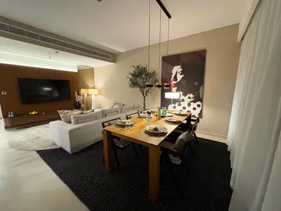 a living room with a table and a couch at Prime Pool Location Spacious Family Villa in Dubai