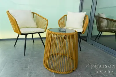 a rattan table and chairs in a room at Modern Luxury Studio Damac Hills With Golf View in Dubai