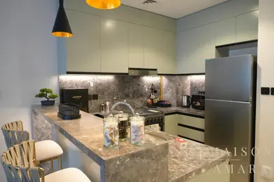 a kitchen with a sink and a refrigerator at Modern Luxury Studio Damac Hills With Golf View in Dubai