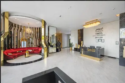 a lobby with a red couch in a store at Serene Golf Course Studio in Artesia Damac Hills in Dubai Marina