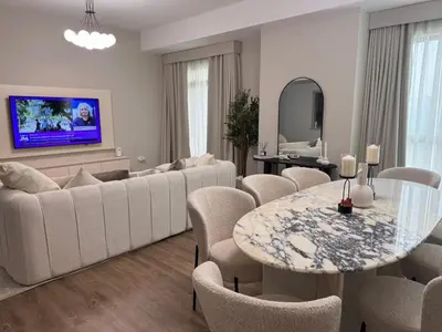 a living room with a couch and a table and chairs at Two bedroom Apartment in JBR Marina - 2 min walk to JBR beach in Dubai