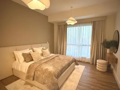 a bedroom with a large bed and a large window at Two bedroom Apartment in JBR Marina - 2 min walk to JBR beach in Dubai