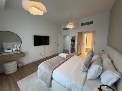 a bedroom with a large white bed and a mirror at Two bedroom Apartment in JBR Marina - 2 min walk to JBR beach in Dubai