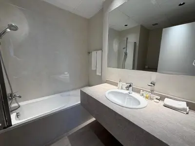 a bathroom with a sink and a bath tub at Two bedroom Apartment in JBR Marina - 2 min walk to JBR beach in Dubai