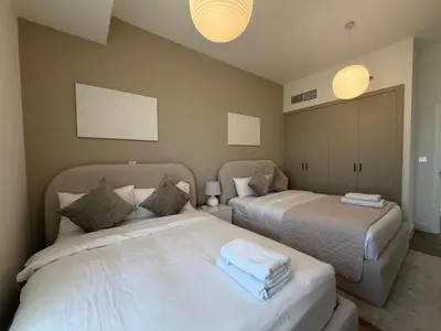 two beds sitting next to each other in a bedroom at Two bedroom Apartment in JBR Marina - 2 min walk to JBR beach in Dubai