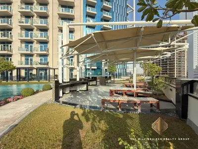 a shadow of a person standing in front of a building at Elegant Studio with Resort Amenities at Miraclez in Dubai