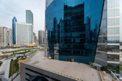 a view of a city with tall glass buildings at Elegant 1BR near downtown w Gym Tennis Basketball Courts in Dubai