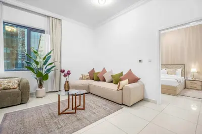 a living room with a couch and a bed at Elegant 1BR near downtown w Gym Tennis Basketball Courts in Dubai