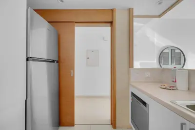 a kitchen with a refrigerator and a sink at Perfect Getaway in Downtown l Near Dubai Mall in Dubai