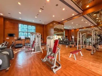 a gym with several treadmills and machines in it at Perfect Getaway in Downtown l Near Dubai Mall in Dubai