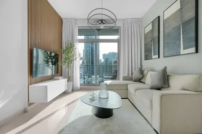 a living room with a couch and a table at Perfect Getaway in Downtown l Near Dubai Mall in Dubai