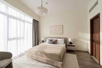 a white bedroom with a bed and a large window at Downtown Dubai - Near Burj Khalifa & DWTC-Gulfood - Imperial Avenue in Dubai