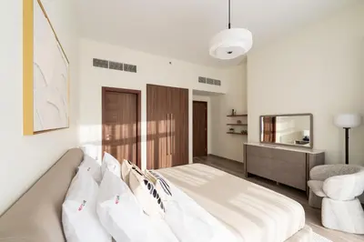 a bedroom with a bed and a chair and a mirror at Downtown Dubai - Near Burj Khalifa & DWTC-Gulfood - Imperial Avenue in Dubai