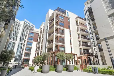 an apartment building with trees in front of it at Silkhaus Stylish 1BDR with Pool & Balcony Dubai Creek Harbour in Dubai