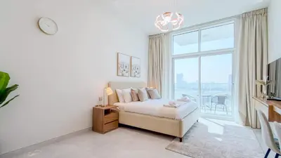 a bedroom with a bed and a large window at TRPS - Skyz by Danube, Arjan - Close to Miracle Garden, Furnished, Brand New in Dubai