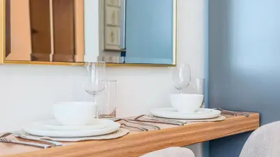 a table with two white cups and plates on it at TRPS - Skyz by Danube, Arjan - Close to Miracle Garden, Furnished, Brand New in Dubai
