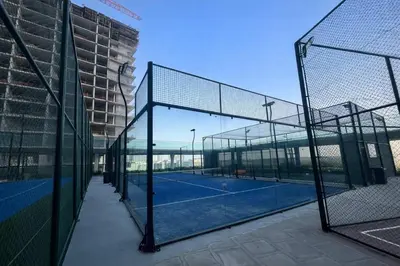 a tennis court with two tennis courts at TRPS - Skyz by Danube, Arjan - Close to Miracle Garden, Furnished, Brand New in Dubai