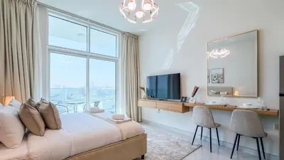 a bedroom with a bed and a desk and a large window at TRPS - Skyz by Danube, Arjan - Close to Miracle Garden, Furnished, Brand New in Dubai